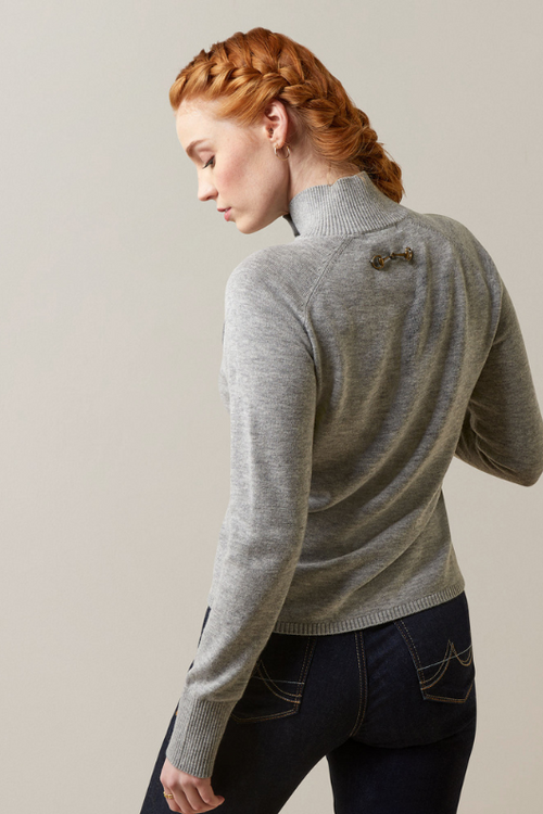 An image of a female model wearing the Ariat Half Moon Bay Sweater in the colour Heather Grey.