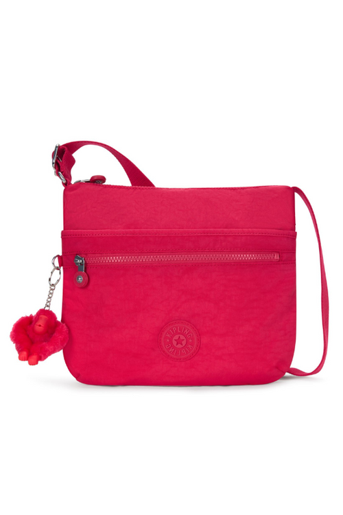 Kipling Arto Shoulder Bag. An across body bag in vibrant pink with an outer zip pocket, round Kipling logo on the front and a Kipling fluffy monkey keychain.
