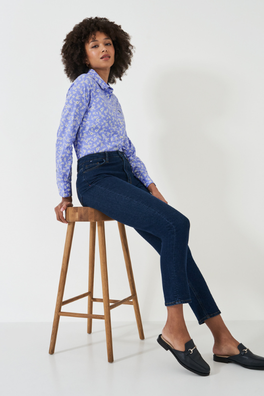 An image of a female model wearing the Crew Clothing Lulworth Shirt in the colour Blue Floral Print.