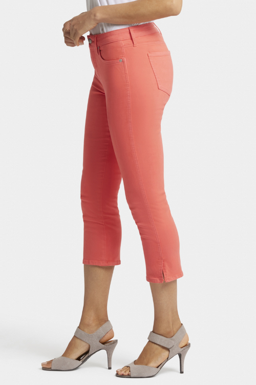 N.Y.D.J Chloe Capri Jeans. Women's cropped jeans with a slim fit, pockets, side slits at the hem, and a chic orange colour design.