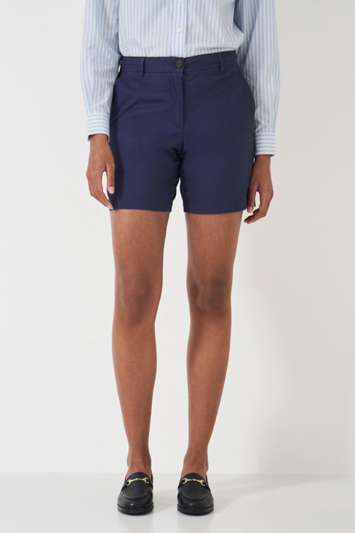 An image of a female model wearing the Crew Clothing Chino Shorts in the colour Navy.