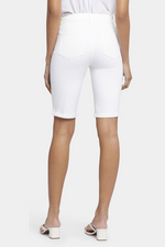 N.Y.D.J Briella Shorts. Knee-length women's shorts with pockets, a sleek fitted silhouette, and a chic white finish.