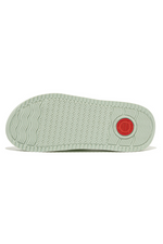 Fitflop Surff Webbing Toe Post Sandals. A pair of sage green sandals with cushioned sole, wedge heel, and wide patterned strap.