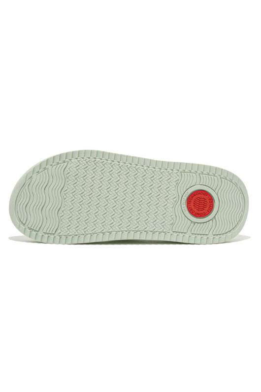 Fitflop Surff Webbing Toe Post Sandals. A pair of sage green sandals with cushioned sole, wedge heel, and wide patterned strap.