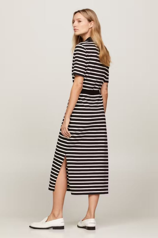 An image of a female model wearing the Tommy Hilfiger Breton Stripe Midi Polo Dress in the colour Black/Calico.