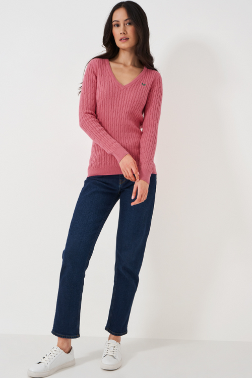 An image of a female model wearing the Crew Clothing Heritage Cable Knit Cotton Cashmere V-Neck Jumper in the colour Rapture Rose.
