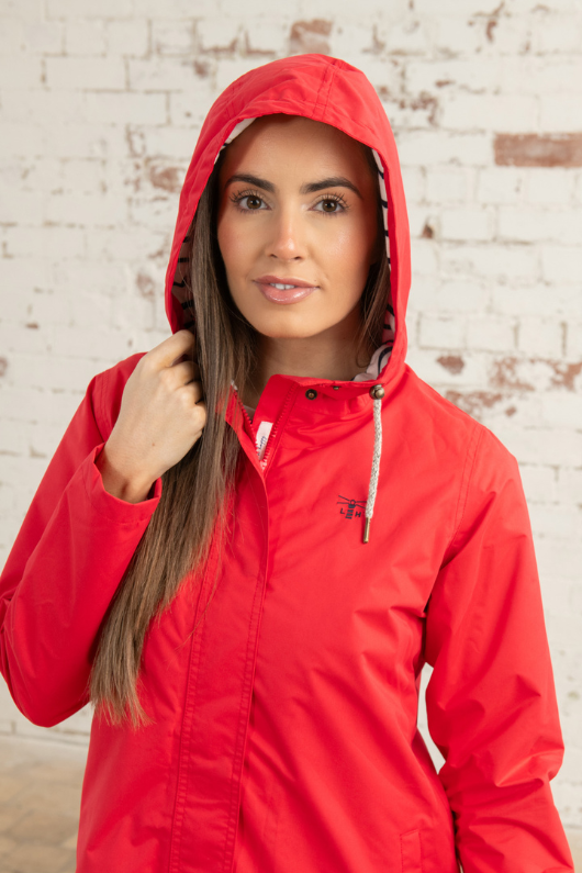 Lighthouse Beachcomber Long Coat. A windproof & waterproof jacket with a soft jersey lining, two-way zip, adjustable hood and a fun red design.