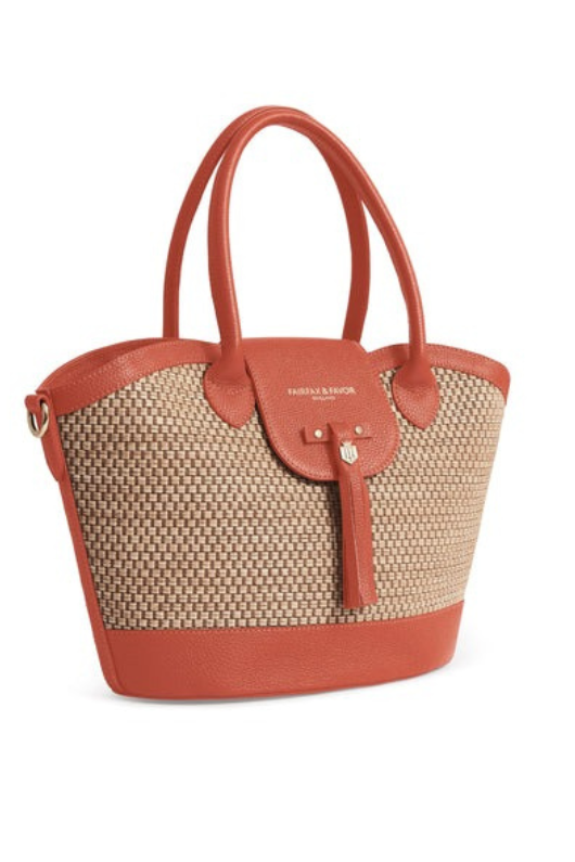 Fairfax & Favor Windsor Leather Basket Bag. A basket bag with Melon coloured details, tassel, crossbody strap, and studded base.