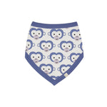 Pigeon Organics Bib. A reversible bib with stripes on one side and purple monkeys on the reverse.