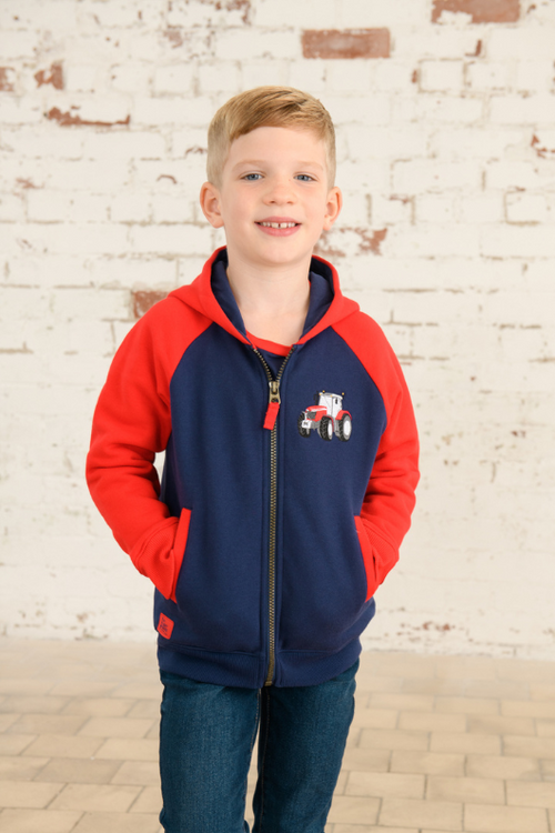 Lighthouse Jackson Full Zip Hoodie. A boys zip-up hoodie with waist pockets, a soft jersey lined hood, and a a navy torso with a tractor piqué on the chest and red sleeves.