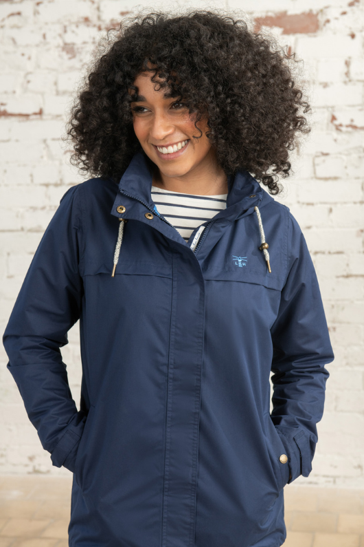 Lighthouse Beachcomber Coat. A lightweight, waterproof jacket with a striped soft jersey lining, pockets, a hip length design, and an adjustable hood.