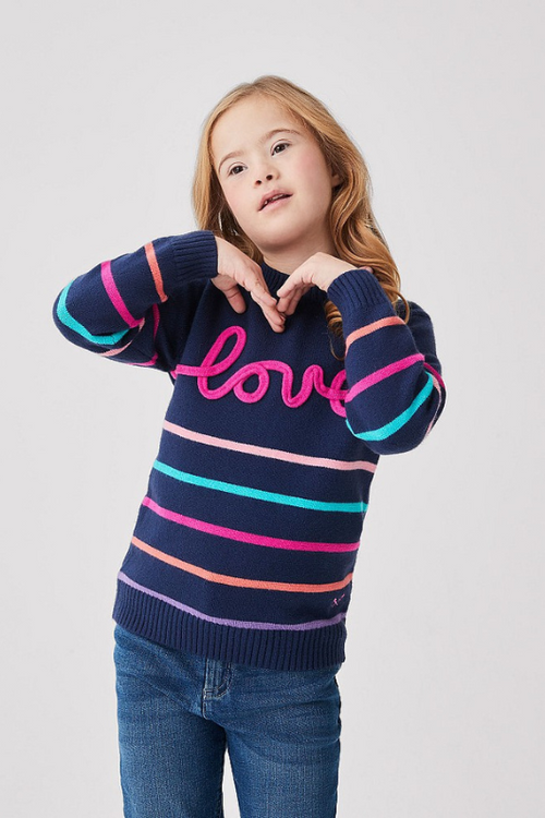 An image of a young girl model wearing the Crew Clothing Love Stripe Jumper in the colour Navy Multi.