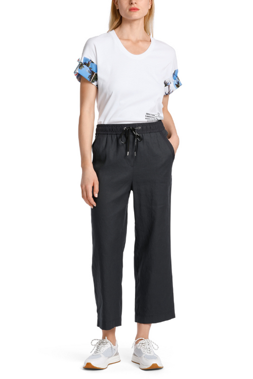 An image of a female model wearing the Marc Cain WUSU Linen Trousers in the colour Midnight Blue.