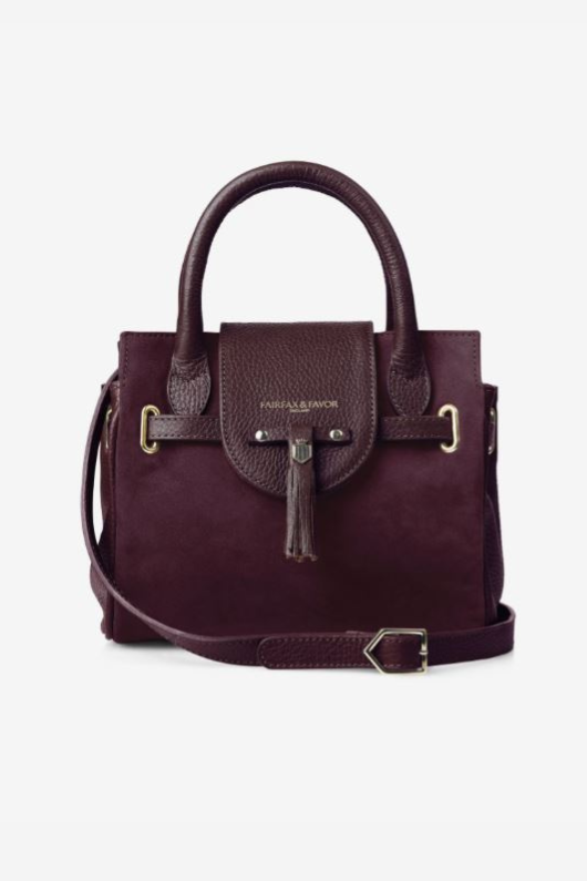 Fairfax & Favor The Mini Windsor. A mini windsor handbag with crossbody strap and tassel details. Suede and leather in the colour Plum.