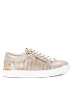 Xti Trainer. A gold women's trainer with lace fastening, zip detail on the side, and a die-cut side with geometric drawing