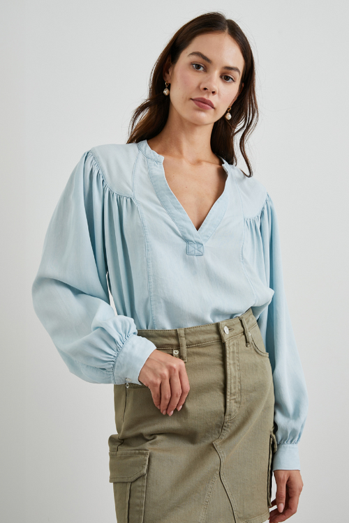 Rails Fable Blouse. A soft, flowing blouse with a V-neck, drop shoulders, long ruched sleeves, and a high-low hem.