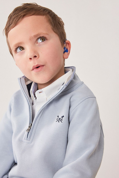 An image of a boy model wearing the Crew Clothing Mini Me 1/2 Zip Sweatshirt in the colour Light Blue.