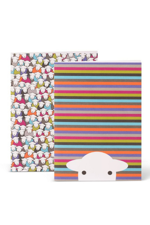 An image of The Herdy Company A5 Notebook- 2 Pack. One notebook has a multi-colour stripe cover with a sheep peering up from the bottom of the front cover. The other has a colourful design with multiple sheep.
