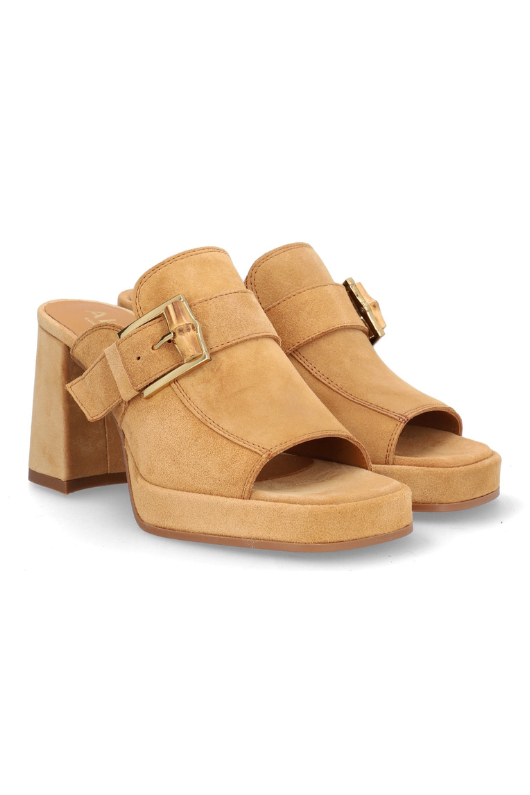 Alpe Platform Slip On Sandal. A tan, block heel sandal with a backless design, open toe, and gold buckle detailing on a suede upper.