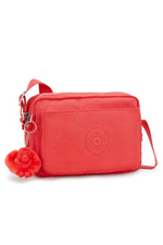 Kipling Abanu Medium Crossbody. A coral crossbody bag with adjustable strap, 2 zipped compartments, multiple pockets, and Kipling logo/monkey charm