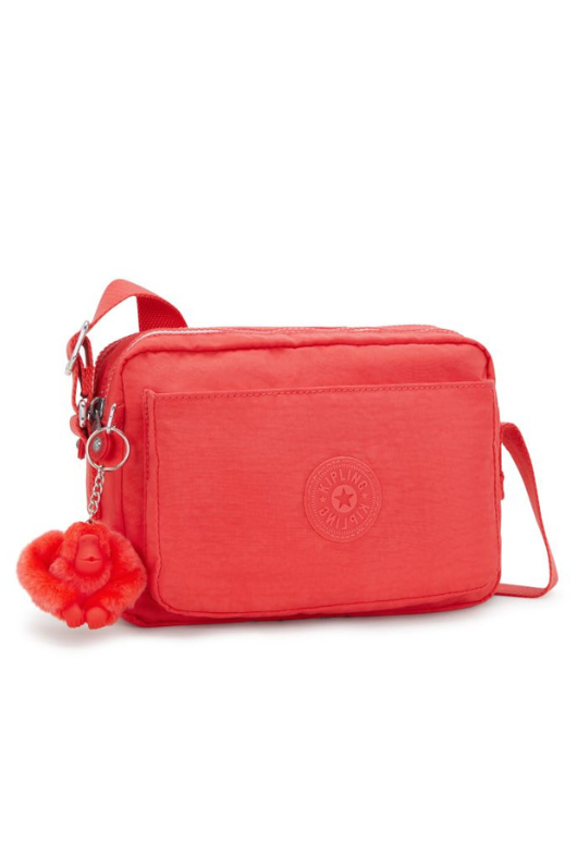 Kipling Abanu Medium Crossbody. A coral crossbody bag with adjustable strap, 2 zipped compartments, multiple pockets, and Kipling logo/monkey charm