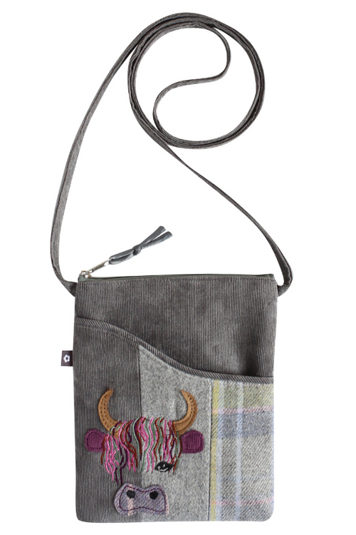 Earth Squared Slingback Applique. A crossbody bag with zip closure, tweed design, and cow applique.