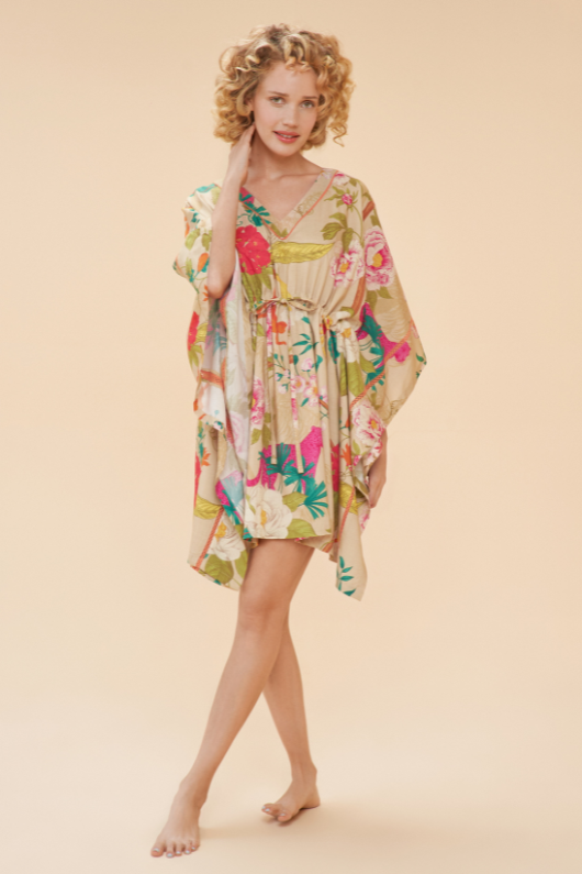 Powder Beach Cover Up. A throw over dress with a drawstring waist for a customised fit, side sleeves, and a vibrant all-over print.