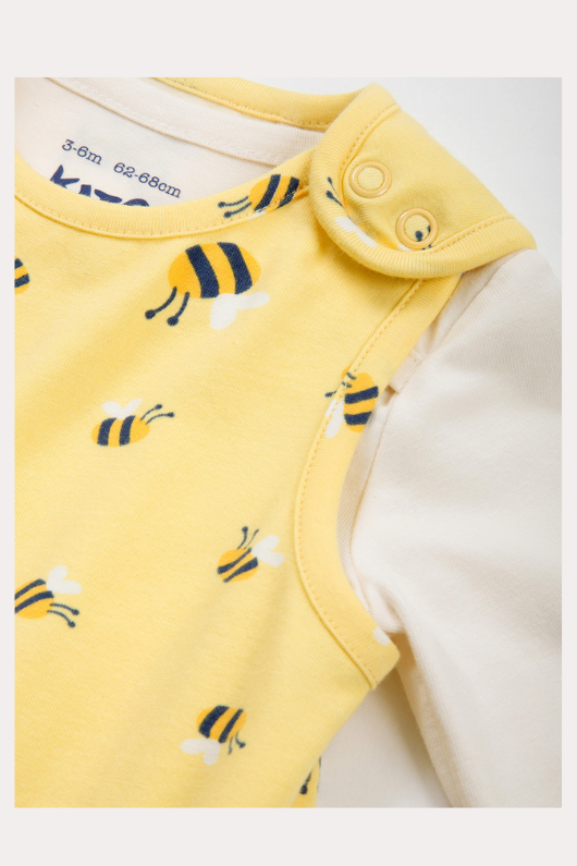 Kite Dungarees. A 2 piece set with cream bodysuit and yellow bumblebee print dungarees. The dungarees feature convenient popper closures.