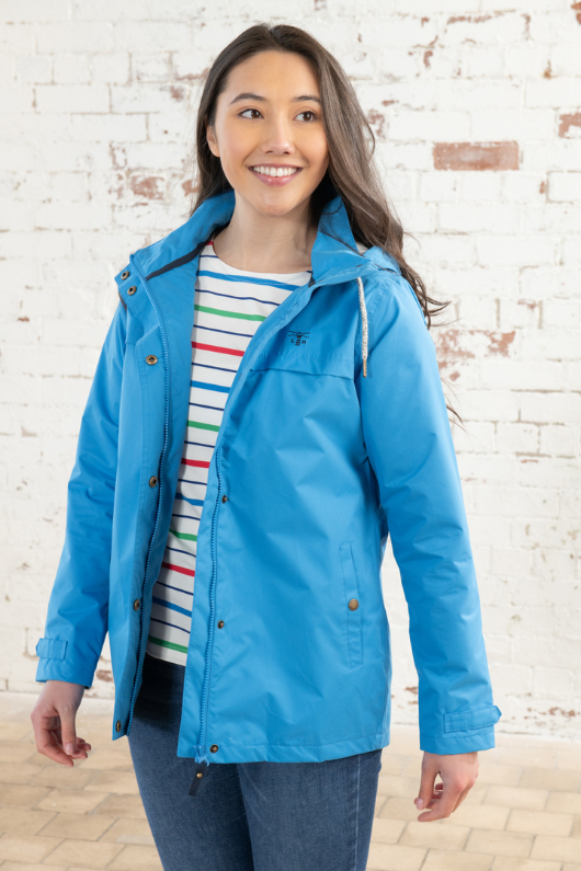 Lighthouse Beachcomber Coat. A lightweight, waterproof jacket with a striped soft jersey lining, pockets, a hip length design, and an adjustable hood.