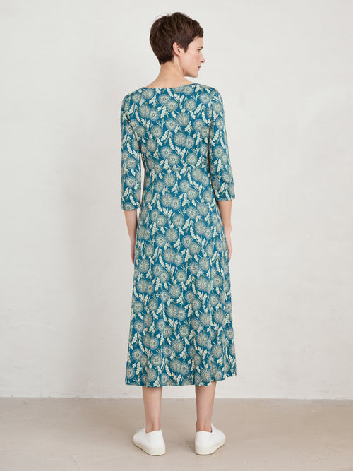Seasalt Secret Cove Dress. A midi length dress with 3/4 length sleeves, sweetheart neckline, and skimming skirt. This dress is green with a dandelion print.