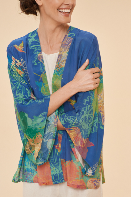 Powder Hummingbird Kimono Jacket. A lightweight jacket with a blue background and a bright colourful floral & hummingbird print