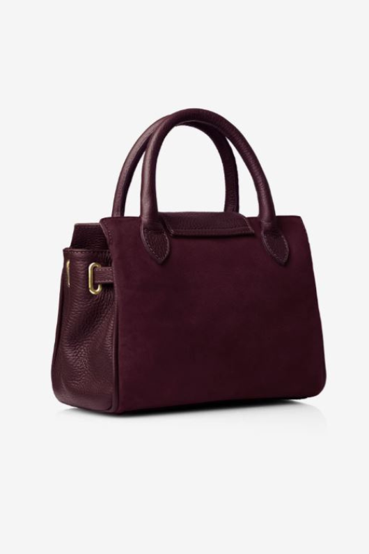 Fairfax & Favor The Mini Windsor. A mini windsor handbag with crossbody strap and tassel details. Suede and leather in the colour Plum.