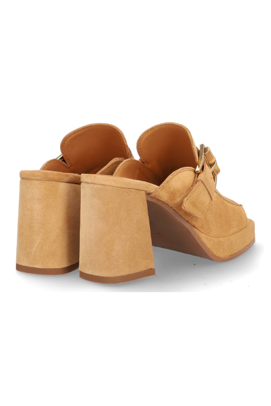 Alpe Platform Slip On Sandal. A tan, block heel sandal with a backless design, open toe, and gold buckle detailing on a suede upper.