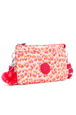 Kipling Riri Small Crossbody Bag in Latin Cheetah. A small zip bag with a pink cheetah print and a fluffy monkey keychain.