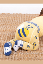 Kite Knit Leggings. A pair of yellow knit leggings with bumble bee print and striped cuffs.