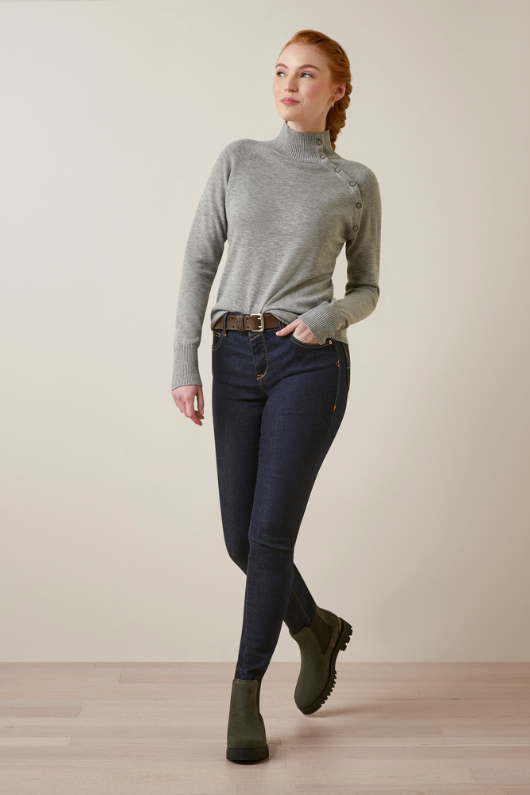 An image of a female model wearing the Ariat Half Moon Bay Sweater in the colour Heather Grey.