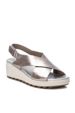Xti Wedge Sandal. A silver, metallic effect women's sandal with velcro strap fastening, an open toe and criss-cross strap detail