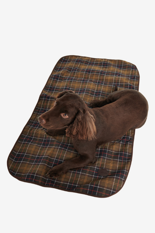 An image of a dog lying on the Barbour Medium Dog Blanket in the colour Classic/Brown.