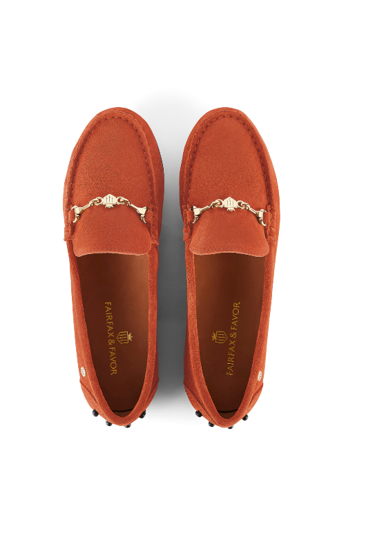 Fairfax & Favor Trinity Suede Loafer. A pair of suede loafers in the colour Sunset Orange, featuring gold hardware and black nubbed sole.