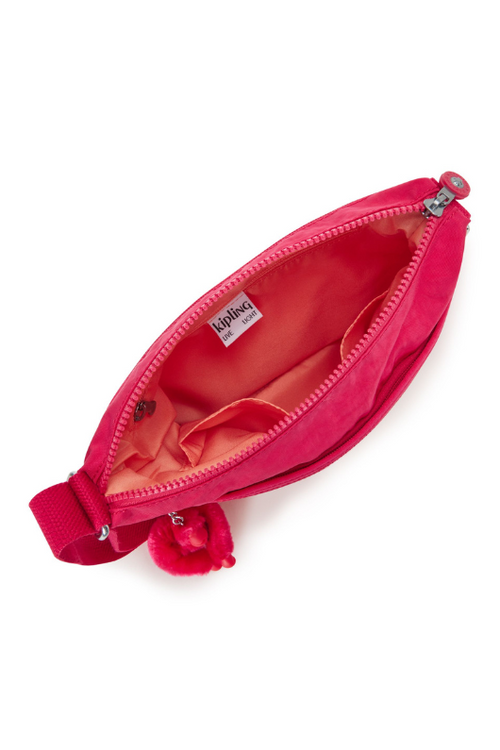Kipling Arto Shoulder Bag. An across body bag in vibrant pink with an outer zip pocket, round Kipling logo on the front and a Kipling fluffy monkey keychain.