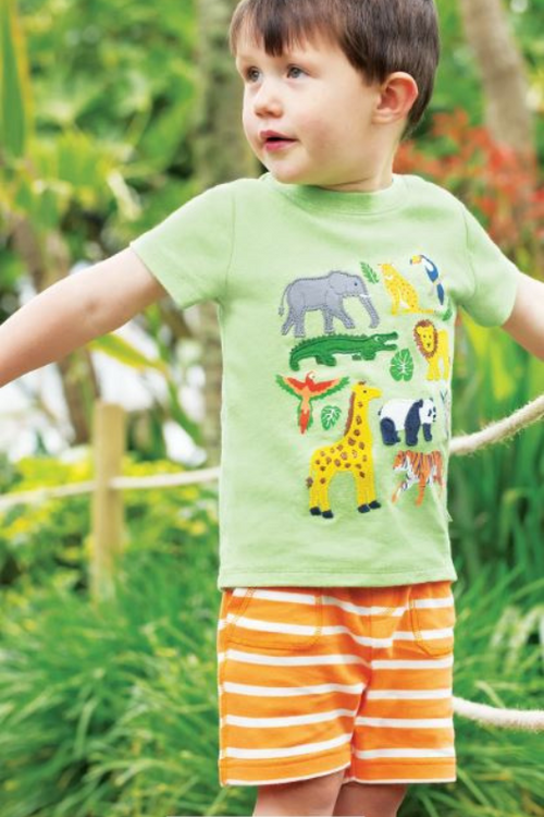 An image of a boy model wearing the Frugi Little Ellis Shorts in the colour Tangerine Breton.