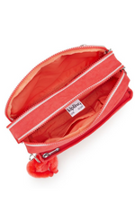 Kipling Abanu Medium Crossbody. A coral crossbody bag with adjustable strap, 2 zipped compartments, multiple pockets, and Kipling logo/monkey charm