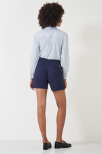 An image of a female model wearing the Crew Clothing Chino Shorts in the colour Navy.