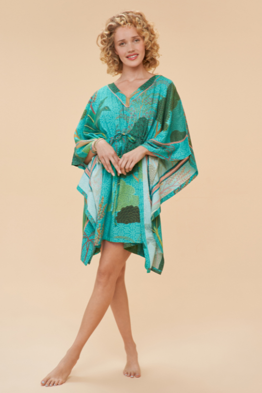 Powder Beach Cover Up. A throw over dress with a drawstring waist for a customised fit, side sleeves, and a vibrant all-over print.