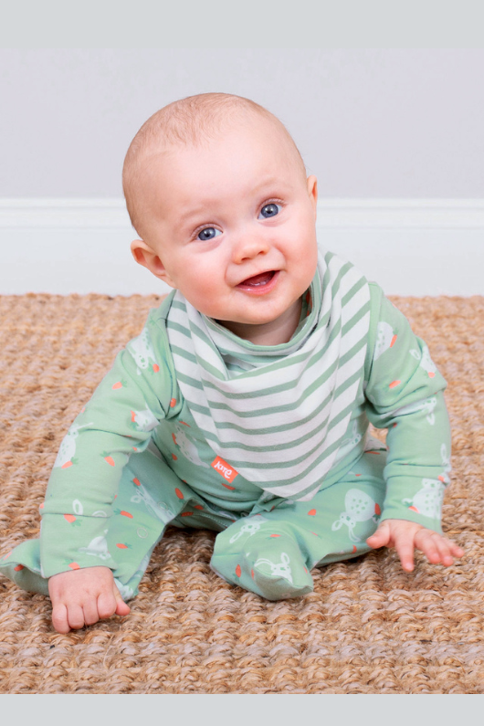 Kite Sleepsuit. A green sleepsuit featuring a bunny print, with poppers on the legs and scratch mitts up to 6 months.