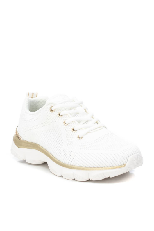 Xti Trainer. A classic women's sneaker with lace-up fastening, a rear pull tab for easy put on, a non-slip rubber sole, and chic gold detail on the eyelets and sole.