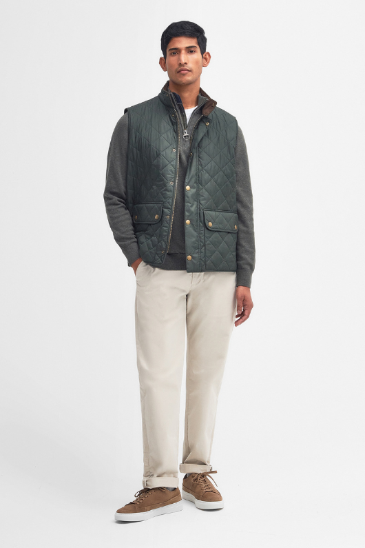 An image of a male model wearing the Barbour Lowerdale Gilet in the colour Sage.