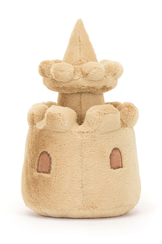 Jellycat Amuseable Sandcastle. A soft toy sandcastle with smiling face, sand coloured fur, and seashell details.