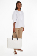 An image of the Tommy Hilfiger Iconic Tommy Perforated Tote in the colour Ecru.