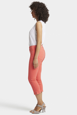 N.Y.D.J Chloe Capri Jeans. Women's cropped jeans with a slim fit, pockets, side slits at the hem, and a chic orange colour design.
